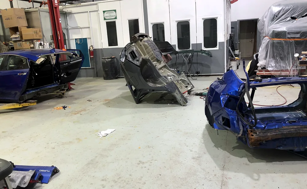 Vehicle sectioned into structural components across the Sultan Motors collision floor during a major repair