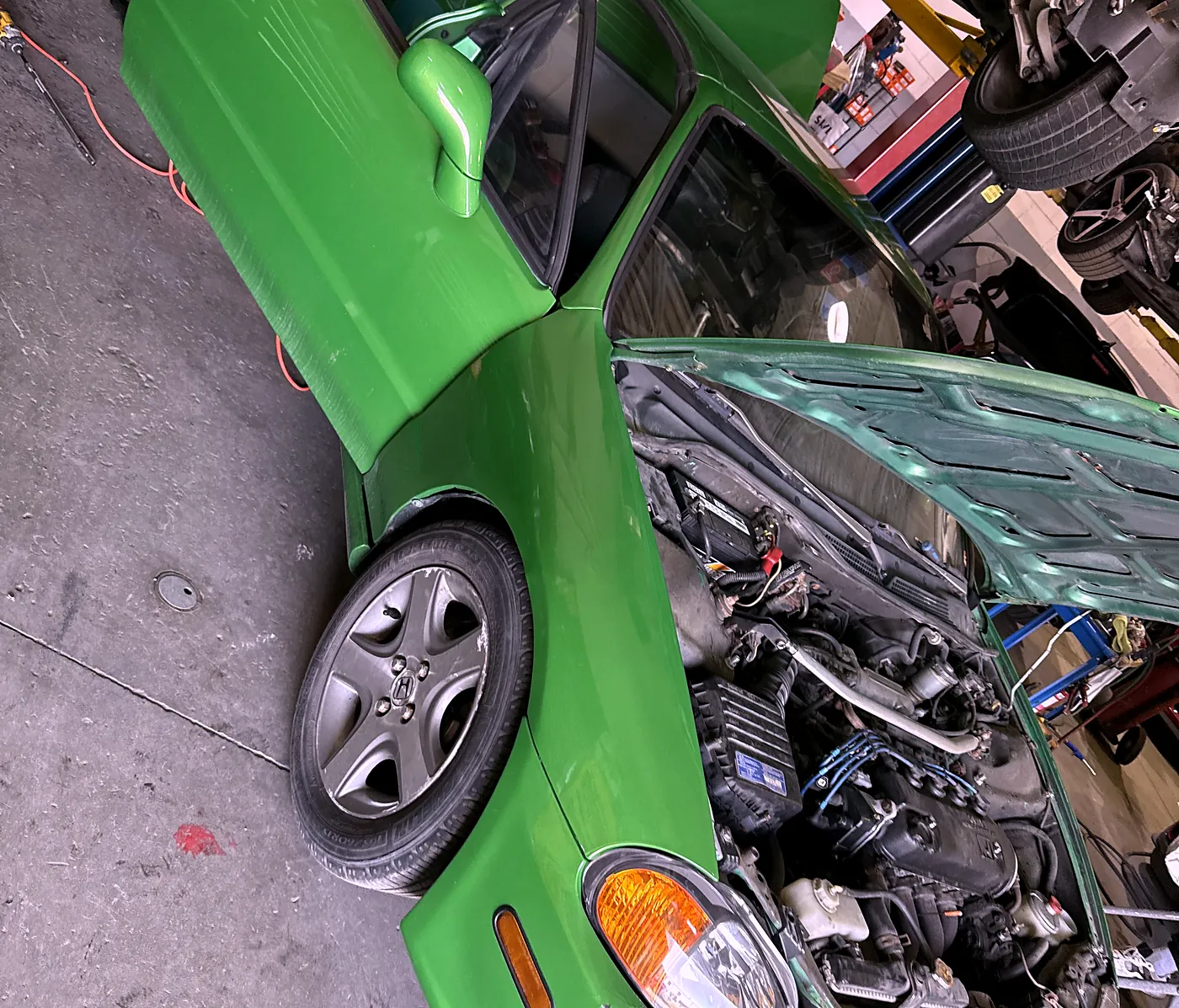 Engine bay opened up for mechanical repair inside the Sultan Motors workshop in Brampton