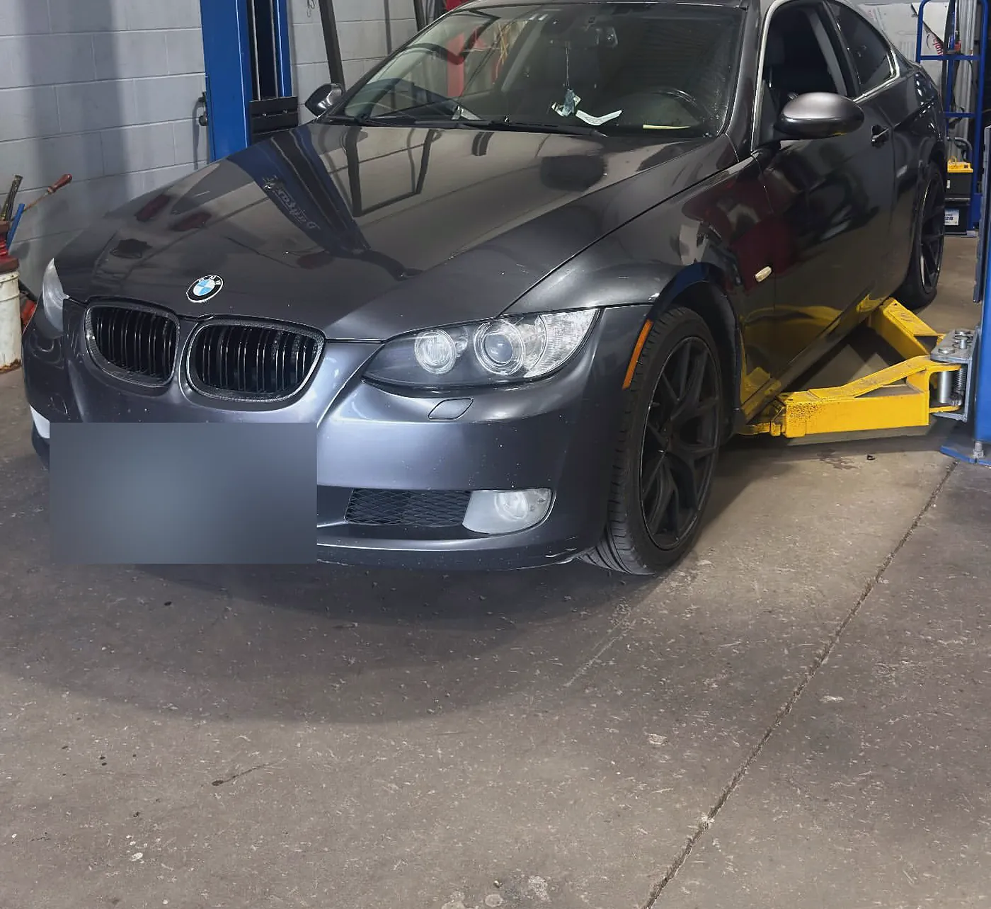 BMW on the hoist at Sultan Motors during a safety inspection and front rotor and pad service